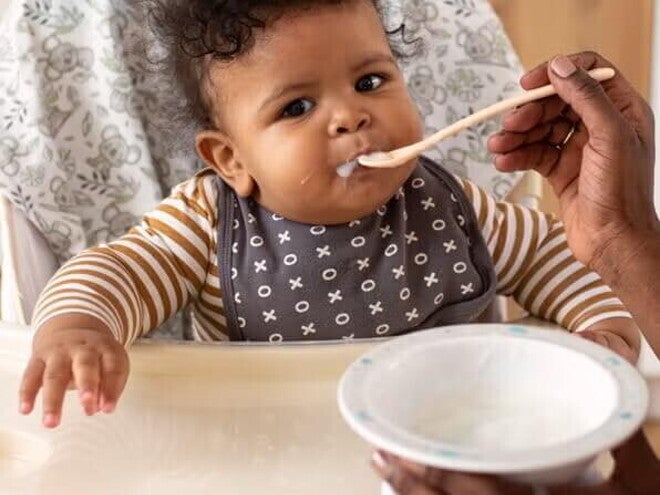 Baby in highchair eating 